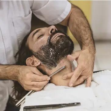 man lying back having a traditional wet shave